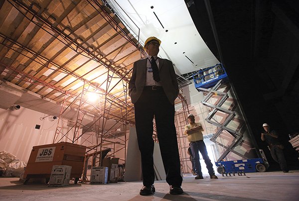 Bobby Roberts (left), the director of Central Arkansas Library System, and J.R. Hensley (middle), project superintendent for Clark Construction, lead a tour of the newly named Ron Robinson Theater in the Arcade Building. 