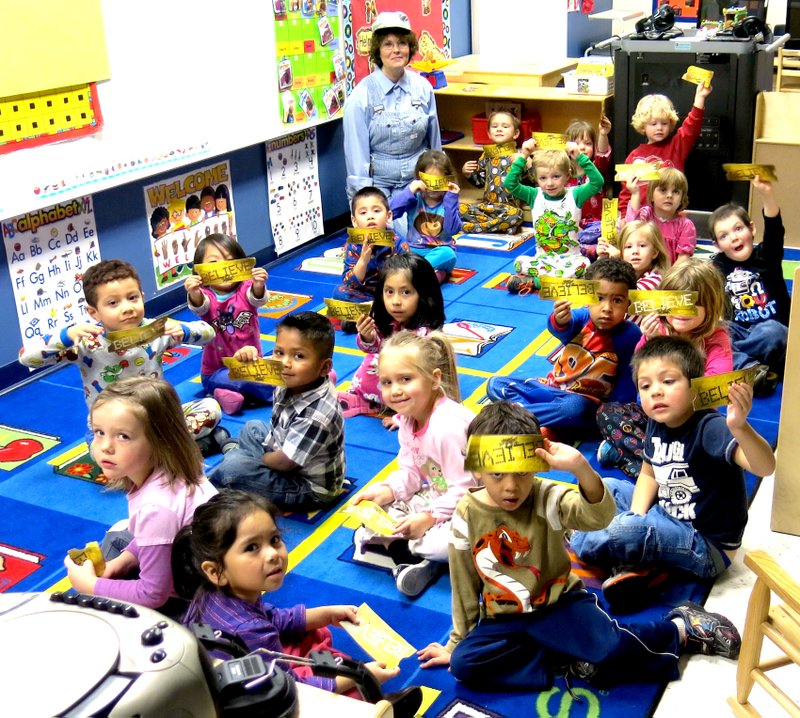 Photo by Mike Eckels Students pf Mrs. Joyce Turnage s Pre-K class , dress in their pajamas, hold up their believe tickets after a ride on the Polar Express on Dec.20. The students at Decatur s Northside Elementary watched the popular Tom Hanks movie Polar Express during the last day of class before Christmas break.