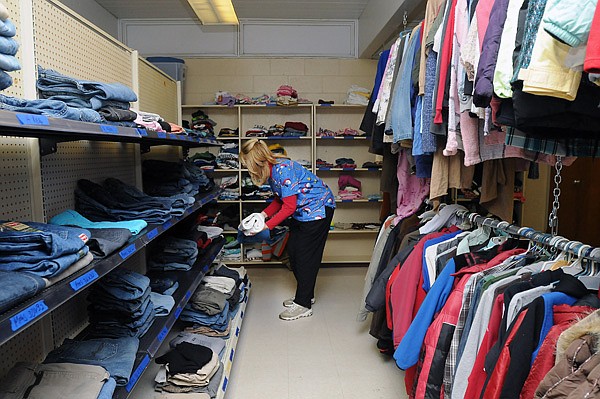 Val Colburn, Pea Ridge Intermediate School nurse and Bright Futures Pea Ridge advisory board member, organizes the Bright Futures Pea Ridge clothing closet Wednesday, Dec. 18, 2013, in the professional development building for the school district in Pea Ridge. The clothing section is part of the overall clothing and pantry closet for Bright Futures Pea Ridge. Basic needs assistance from Bright Futures Pea Ridge is accessible to all of the more than 1,800 students within the district. The program was first started in the Joplin School District in 2011.