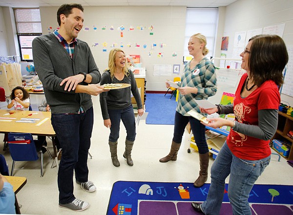 Leverett Elementary School assistant principal Joe McClung (left to right) visits with principal Cheryl Putnam, parent Ellen Allen and kindergarten teacher Stephanie Wood as Putnm relays information concerning high student performance in Wood's classroom Friday afternoon Dec. 20, 2013 in Fayetteville. A Commissioner's memo  from the Arkansas Department of Education recognized the the school being in the top ten percent in the state in areas of the Arkansas Benchmark Assessment and have made financial awards available to the school.