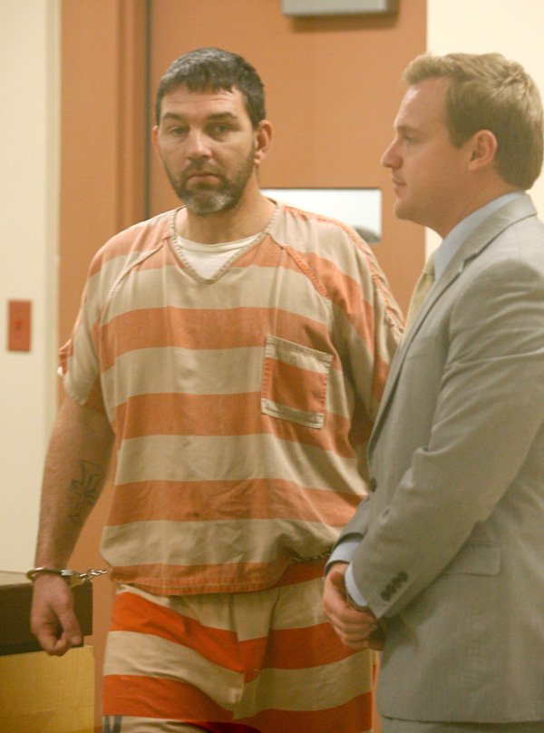 Timothy Swinford is led into the courtroom on Wednesday, Jan. 30, 2013, at the Washington County Jail in Fayetteville for arraignment with Judge Ray Reynolds. Swinford is one of four facing felony charges in connection with accomplice to capital murder, engaging in violent criminal group activity and kidnapping.