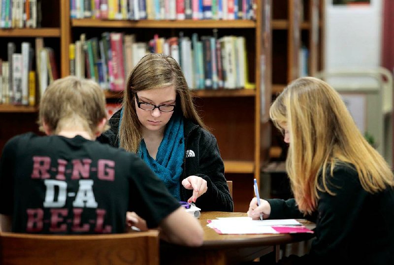 NWA Media/JASON IVESTER --12-20-2013--
Springdale High sophomores Garrett Story (from left), Cassidy King and Allie (cq) Dill study in the school library on Friday, Dec. 20, 2013, for their final exams. A $25.88 million grant from the U.S. Department of Education will support the district's efforts to rethink the high school experience.