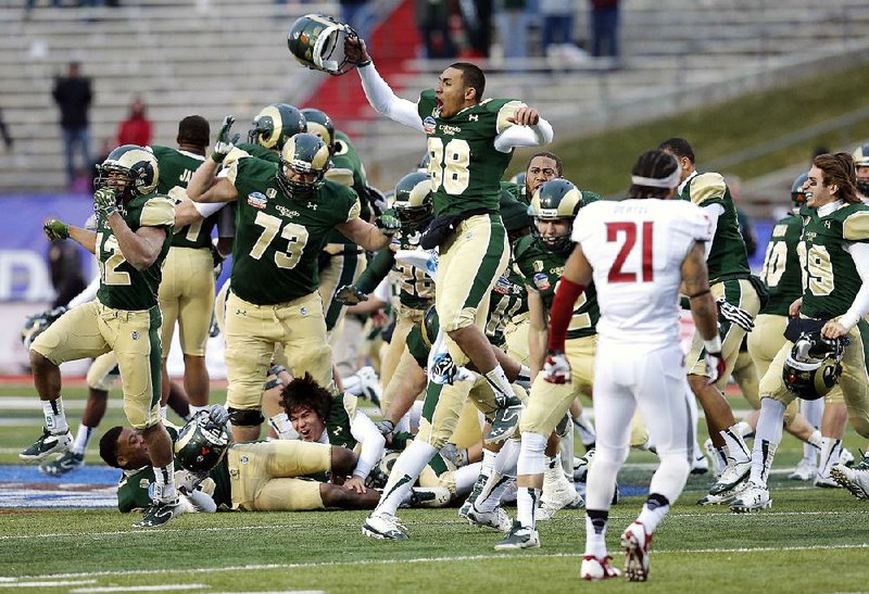 Colorado State players celebrate their win after the NCAA New Mexico Bowl college football game against Washington State, Saturday, Dec. 21, 2013, in Albuquerque, N.M. Colorado State won 48-45.(AP Photo/Matt York)