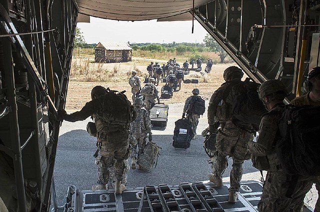 In this photo taken Wednesday, Dec. 18, 2013 and released by the U.S. Air Force, soldiers of the East Africa Response Force (EARF), a Djibouti-based joint team assigned to Combined Joint Task Force-Horn of Africa, depart from a U.S. Air Force C-130 Hercules in Juba, South Sudan to support with an ordered departure of personnel from the city. Gunfire hit three U.S. military CV-22 Osprey aircraft Saturday, Dec. 21, 2013 trying to evacuate American citizens in Bor, the capital of the remote region of Jonglei state in South Sudan, that on Saturday became a battle ground between South Sudan's military and renegade troops, officials said, with four U.S. service members wounded in the attack. (AP Photo/U.S. Air Force, Tech. Sgt. Micah Theurich)