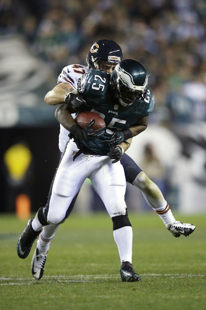 Philadelphia Eagles' LeSean McCoy, right, is tackled by Chicago Bears' Chris Conte during the first half of an NFL football game, Sunday, Dec. 22, 2013, in Philadelphia. (AP Photo/Michael Perez)