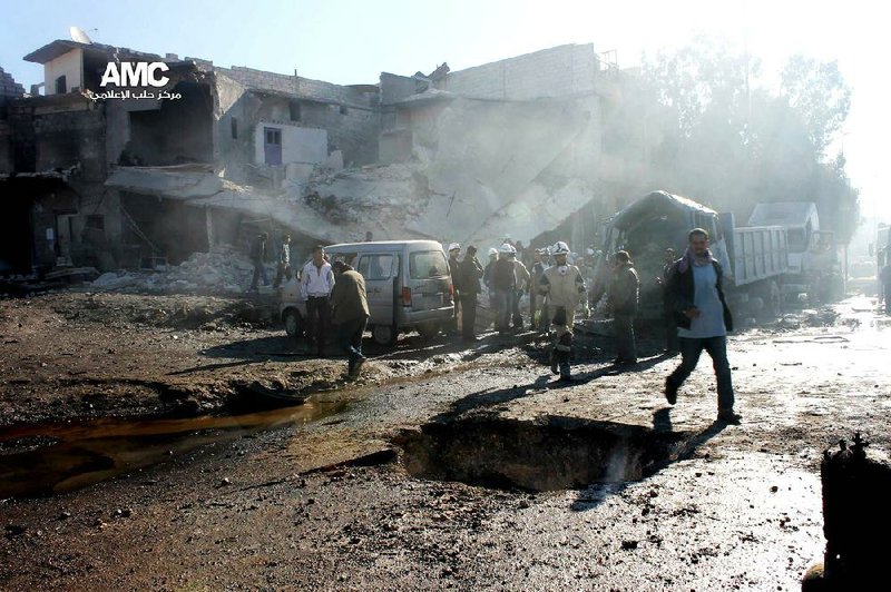 In this citizen journalism image provided by Aleppo Media Center, AMC, which has been authenticated based on its contents and other AP reporting, Syrians inspect the scene after an aircraft pummeled masaken hanano, an opposition neighborhood in the northern city of Aleppo, Syria, Sunday, Dec. 22, 2013. Syrian aircraft pummeled an opposition neighborhood in the northern city of Aleppo on Sunday, killing scores and extending the government's furious aerial bombardment of the rebel-held half of the divided city to an eighth consecutive day. (AP Photo/Aleppo Media Center AMC)