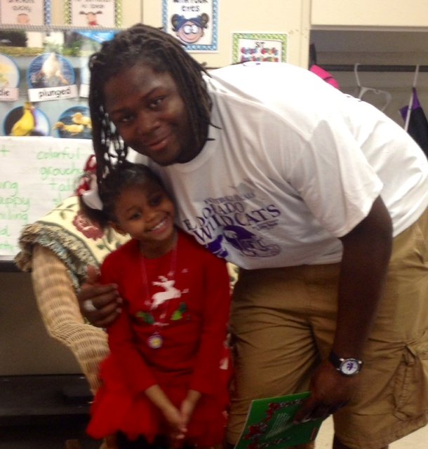 Arkansas defensive line commitment Bijhon Jackson poses with his sister, Tiana during a visit to Hugh Goodwin elementary to read to a class of kindergartners.  