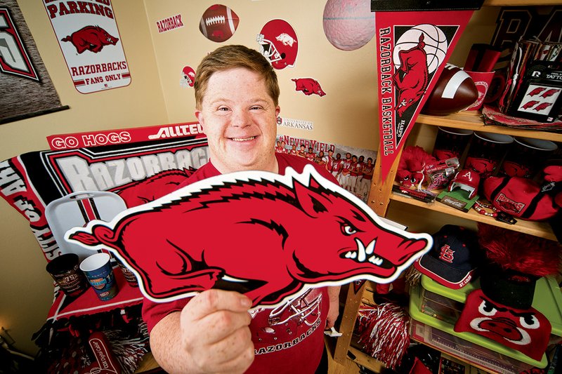 Canaan Sandy of Cave City shows some of the Hog memorabilia in his Razorback-themed bedroom. An avid Razorbacks fan, he was recently inducted into the ESPN Fan Hall of Fame as one of the nation’s top-three sports fans.