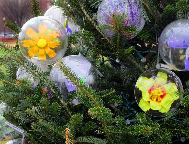 Fourth-grade students from the Northwest Environmental Studies Academy in El Dorado created these Christmas ornaments, which hang on a tree across the street from the White House. The glass orbs hold handmade Arkansas blanket flowers, black-eyed susans, blackberry lilies and dog’s-tooth violets. 