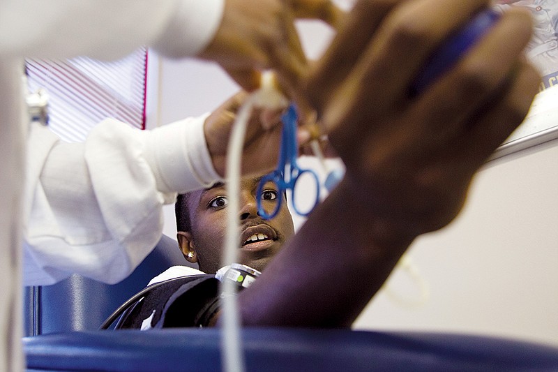 Jermaine Marshall of Little Rock donates blood at a fraternity-sponsored blood drive over the summer. This winter, the Red Cross is partnering with college campuses across Arkansas to help increase the blood supply during January, National Blood Donor Month.