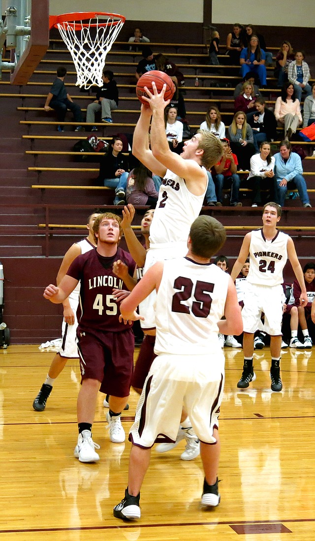 Photo by Randy Moll Gentry senior, Jarod Cousins, attempts a shot for two under the basket in play against the Lincoln Wolves on Monday, Dec. 15, at Gentry High School.