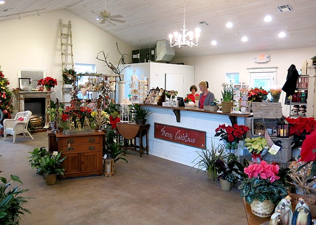 Photo by Randy Moll The Garden Gate flower shop has moved from Main Street to a new, roomier location at 1030 S. Gentry Blvd., Gentry. The shop, in a newly-constructed building, is adjacent to the Wooden Spoon Restaurant. A grand opening is being planned for some time in January.