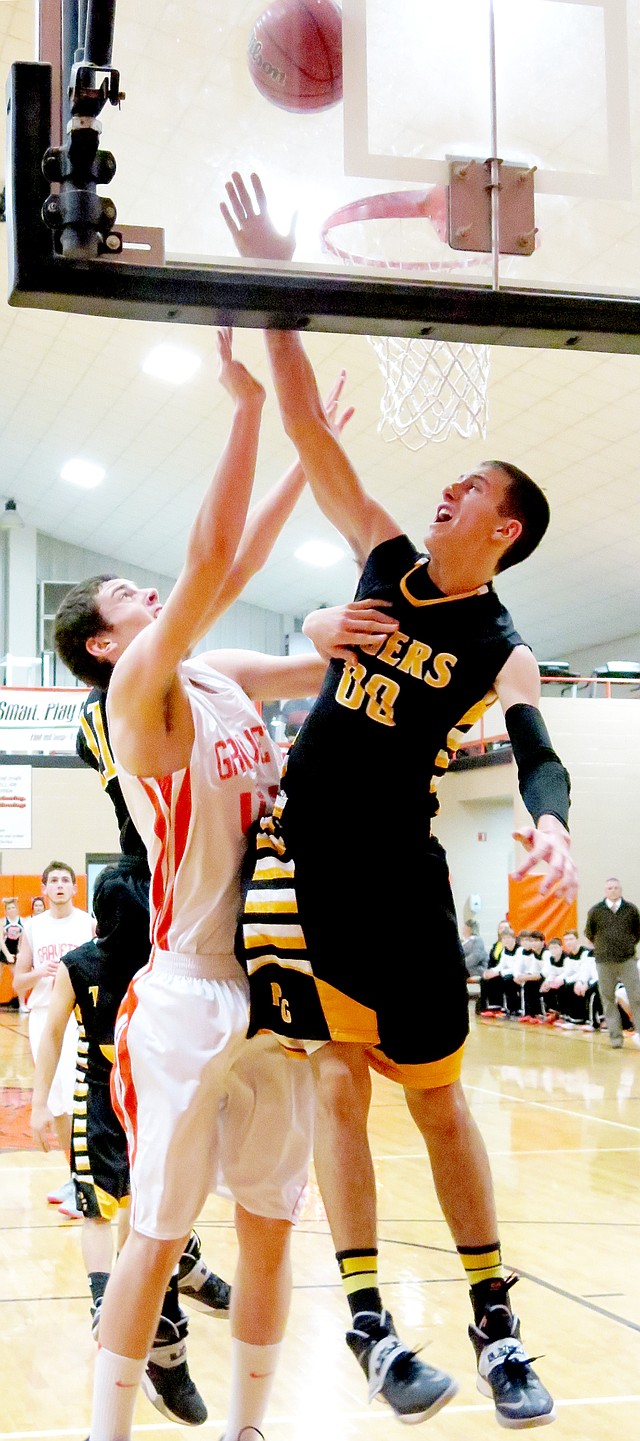 Photo by Randy Moll Prairie Grove s Tanner Purcell attempts to block a shot by Gravette senior, Otto Troutner, during play in Gravette on Friday.