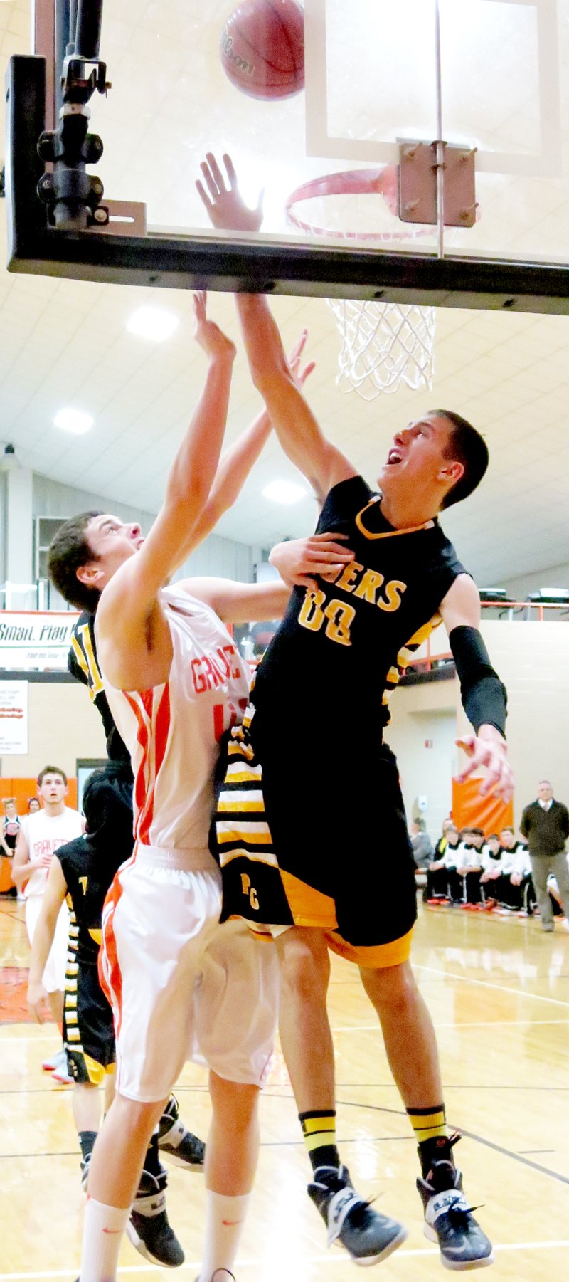 Photo by Randy Moll Prairie Grove s Tanner Purcell attempts to block a shot by Gravette senior, Otto Troutner, during play in Gravette on Friday.