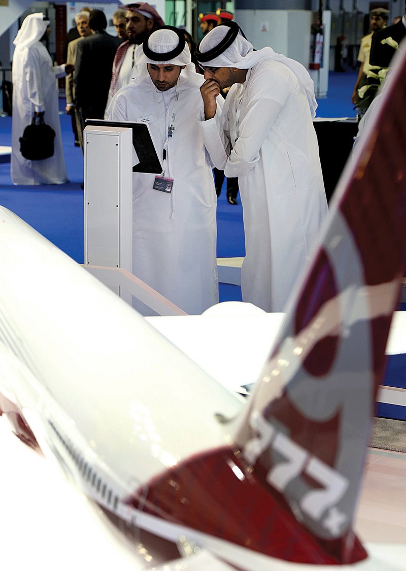 Visitors look at a model of a Boeing 777X aircraft at a Boeing display last month at the 13th Dubai Airshow in Dubai, United Arab Emirates. 