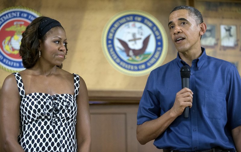 President Barack Obama speaks to members of the military and their families as first lady Michelle Obama stands left in Anderson Hall at Marine Corps Base Hawaii, Wednesday, Dec. 25, 2013, in Kaneohe Bay, Hawaii. The first family is in Hawaii for their annual holiday vacation.