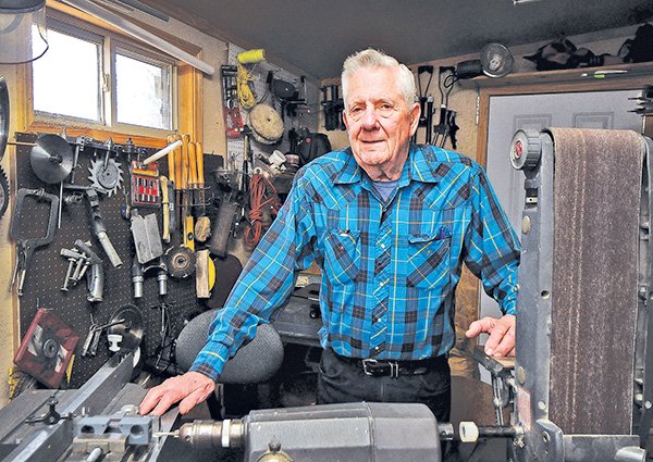     STAFF PHOTO BEN GOFF 
Jim Kysilka poses for a photo Monday in the workshop at his Rogers home. Kysilka, a retired engineer, has helped Open Avenues by fabricating tools and machines for handicapped workers.