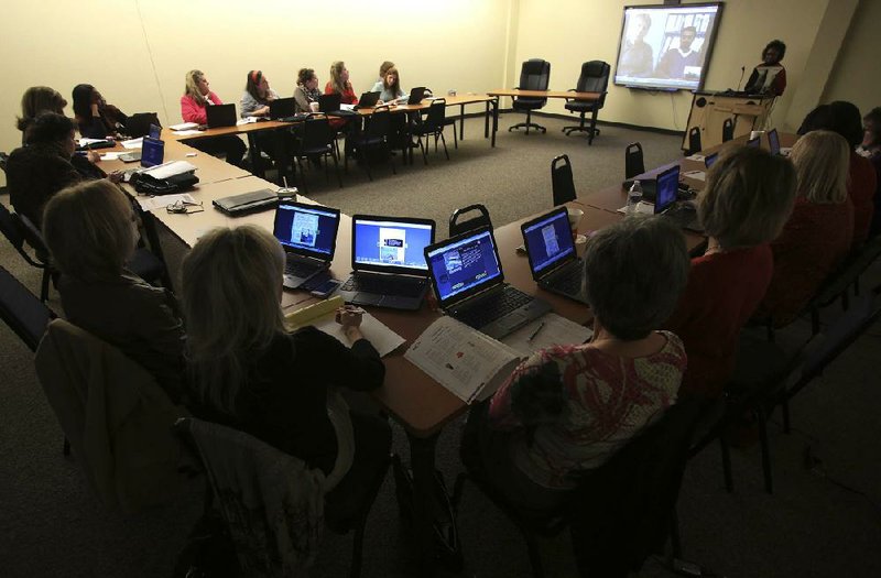  Arkansas Democrat-Gazette/STATON BREIDENTHAL --12/17/13-- Teachers video conference with officials from a school in California during a Little Rock School District training session on one to one computing. Some students in the district will be getting issued laptops to use in classrooms and to take home beginning next semester. 