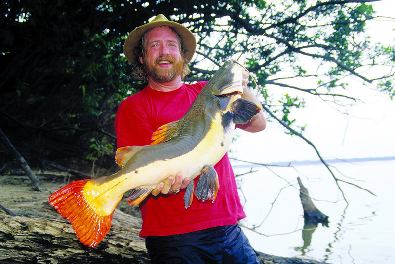Keith Sutton poses with the red-tailed catfish he caught just before Christmas 2000 in Brazil.