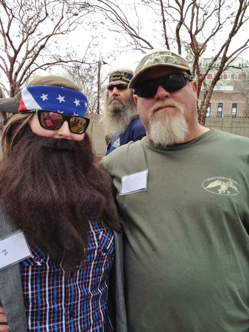 Mary Kate Denis, 17, of Jacksonville, left, aka Willie Robertson, winner of a Duck Commander celebration held in Monroe, La., poses with another contestant portraying Duck Dynasty star John Godwin.