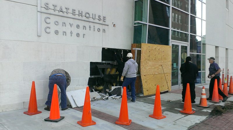 Workers assess the damage to the Statehouse Convention Center in Little Rock after a driver crashed into the building Friday, Dec. 27, 2013.