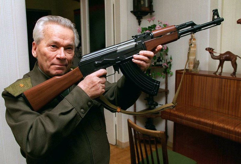 In this Oct. 29, 1997 file photo, Mikhail Kalashnikov, who died Monday, shows a model of his world-famous AK-47 assault rifle at home in the Ural Mountain city of Izhevsk, 1000 km (625 miles) east of Moscow, Russia. 