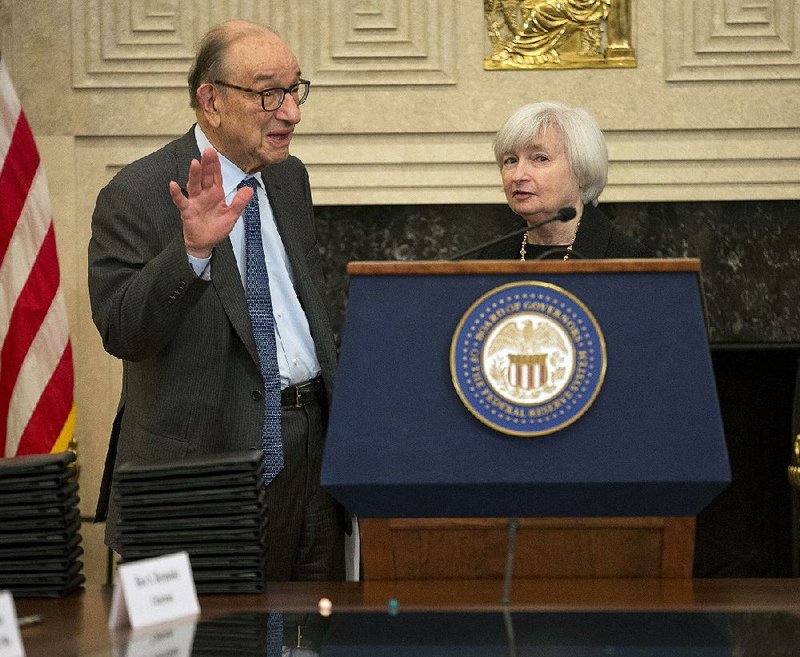 Former chairman of the Federal Reserve Alan Greenspan, left, talks with Janet Yellen,  right, Vice Chair of the Board of Governors of the Federal Reserve and successor to current chairman Ben Bernanke, before taking their seat to participate in the ceremonial signing of a certificate commemorating the 100th anniversary of the signing of the Federal Reserve Act, Monday, Dec. 16, 2013 at the Federal Reserve Building in Washington. Joined by his two predecessors, Bernanke marked the 100th anniversary of the Federal Reserve by reflecting on the bold actions past chairmen have had to take in the best interest of the U.S. economy. (AP Photo/Pablo Martinez Monsivais)