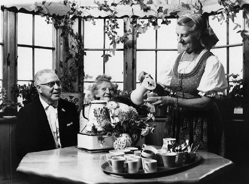 In this photo taken on Dec. 5, 1962, Maria von Trapp performs a pleasant daily ritual, pouring coffee for two guests at the lodge she runs in Stowe, Vt. The von Trapp family settled in Stowe in 1942 after fleeing the Nazis in Austria in 1938. 