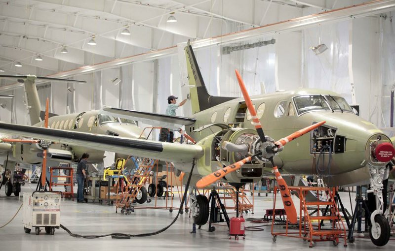 FILE - In this Monday, Feb. 18, 2013, file photo, aircraft are worked on on the assembly line at Beechcraft in Wichita, Kan. Textron Inc., the parent company of Cessna Aircraft, announced Thursday, Dec. 26, 2013, that it has reached an agreement to buy Beechcraft Corp. for approximately $1.4 billion. (AP Photo/The Wichita Eagle,  Jaime Green) LOCAL TV OUT; MAGS OUT; LOCAL RADIO OUT; LOCAL INTERNET OUT