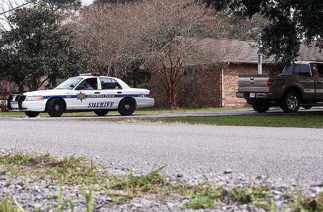 A Lafourche Parish Deputy guards the crime scene at Lafourche Parish councilman Phillip Gouaux’s home Friday, Dec. 27, 2013, in Lockport, La. Three were killed and three injured in a Thursday evening shooting spree in Lafourche and Terrebonne Parishes. (AP Photo/The Daily Comet, Abby Tabor)