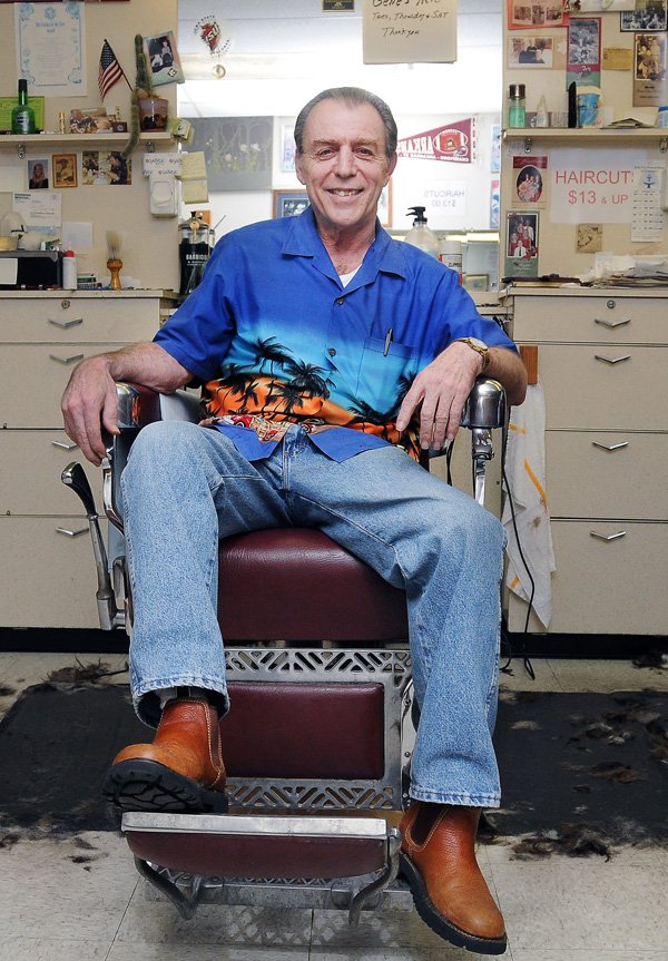 Gene Wolf sits in his barber shop Thursday, Dec. 19, 2013, at 111 W. Central Ave. in Bentonville. Wolf, who has been cutting hair at Gene's Barber Shop for 20 years, will be retiring at the end of the month after 46 years in the business.