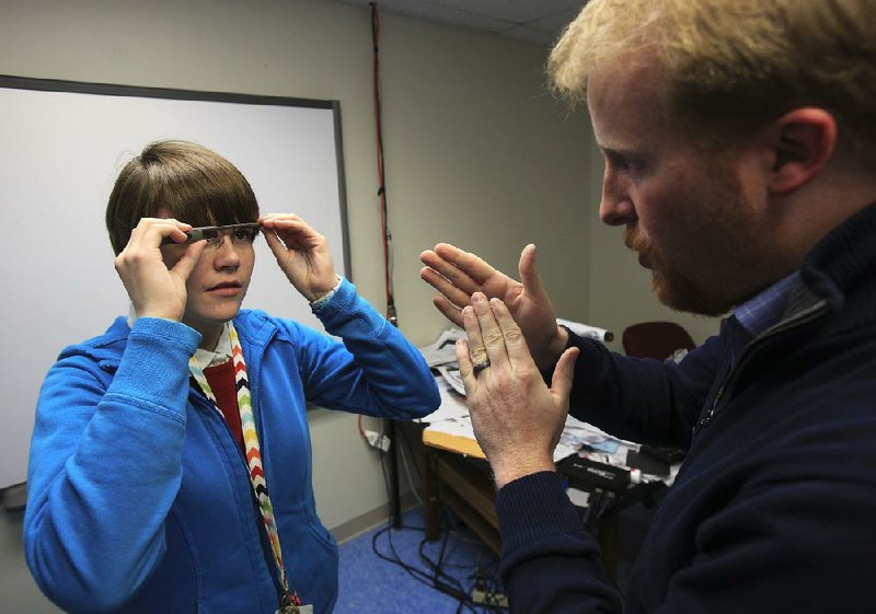  Arkansas Democrat-Gazette/STATON BREIDENTHAL --12/12/13-- Director Corey Alderdice (right) (cq) gives student Vic Antley, 16, of Lockesburg, Ark., tips on using the Google Glass as she scrolls through a website while using the glasses at the Arkansas School for Mathematics, Sciences, and the Arts in Hot Springs. The school was selected as a test site for Google Glass.