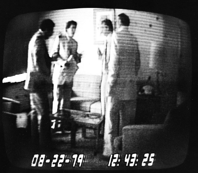 Then-U.S. Rep. Michael Myers (second from left) holds an envelope with $50,000 after receiving it from undercover FBI agent Tony Amoroso (left) in this government surveillance tape rebroadcast by NBC during the first Abscam trial in October 1980. Also shown are co-defendant Angelo Errichetti (second from right) and con man Melvin Weinberg. 