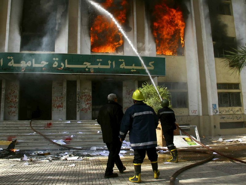 Firefighters in Cairo battle flames Saturday at the Faculty of Commerce administration building at Al-Azhar University, which the Egyptian Interior Ministry said students set ablaze. But a student spokesman said police set the fire and blamed it on peacefully protesting students. 