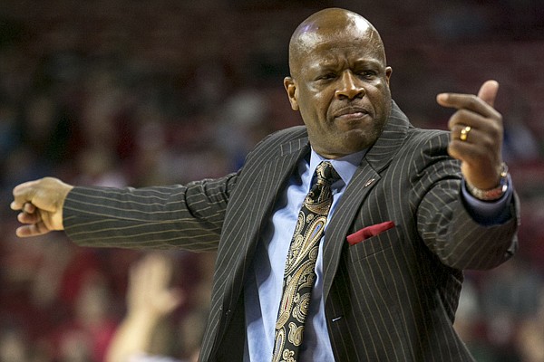 Arkansas coach Mike Anderson signals for players on the bench during the second half of an NCAA college basketball game against High Point on Saturday, Dec. 28, 2013, in Fayetteville, Ark. Arkansas defeated High Point 89-48. (AP Photo/Gareth Patterson)