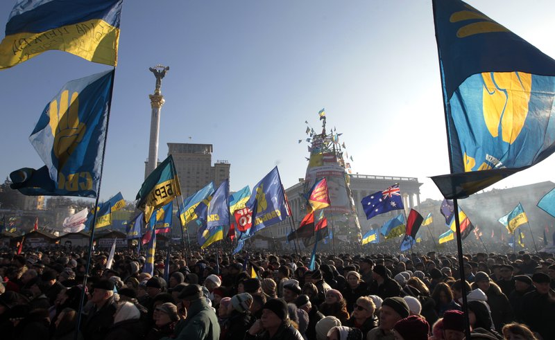 Pro-European Union activists gather in Independence Square in Kiev, Ukraine, Sunday, Dec. 29, 2013. About 20,000 people protested in Ukraine’s capital on Sunday, maintaining more than a month of rallies opposing the government’s decision to shelve a key deal with the European Union. (AP Photo/Sergei Chuzavkov)