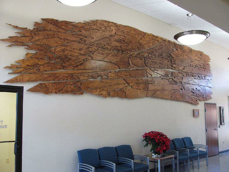 Arkansas Democrat-Gazette/DAVE HUGHES....The 26-foot-long mural "Alma: Doorway to the Ozarks" erected in June in the front lobby wall of the Alma Police Department is an abstract map of the Alma area. It was created by Fayetteville artist Matthew Meers using 15 original interior doors from the building that underwent renovation.