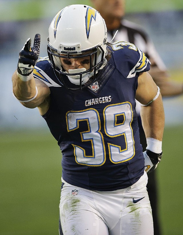 San Diego Chargers running back Danny Woodhead gives the first down signal after catching  a pass in the overtime period of the Chargers' 27-24 victory over the Kansas City Chiefs in an NFL football game Sunday, Dec. 29, 2013, in San Diego. The victory put the Chargers into the playoffs.  (AP Photo/Lenny Ignelzi)