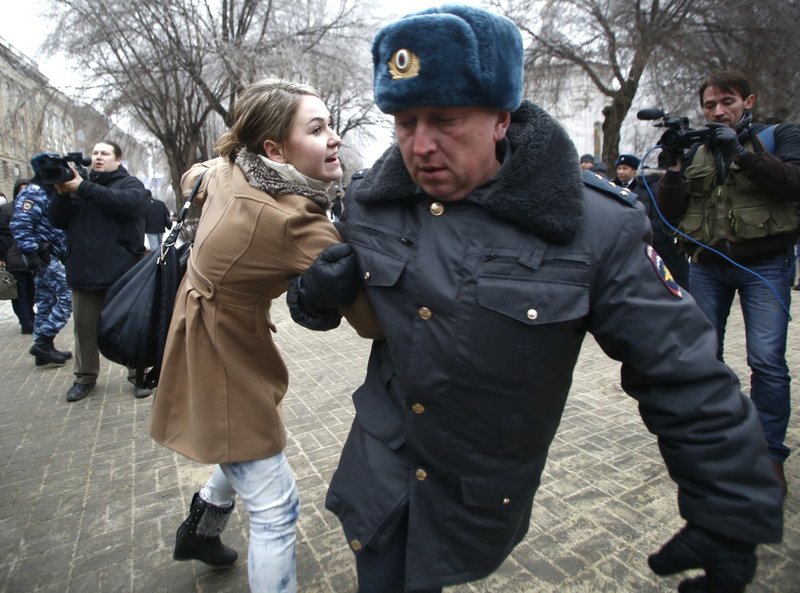 Police officers detain people who gathered for an unsanctioned event in downtown Volgograd, Russia, on Monday, Dec. 30, 2013. Volgograd is about 400 miles northeast of Sochi, where the Olympics are to be held. 