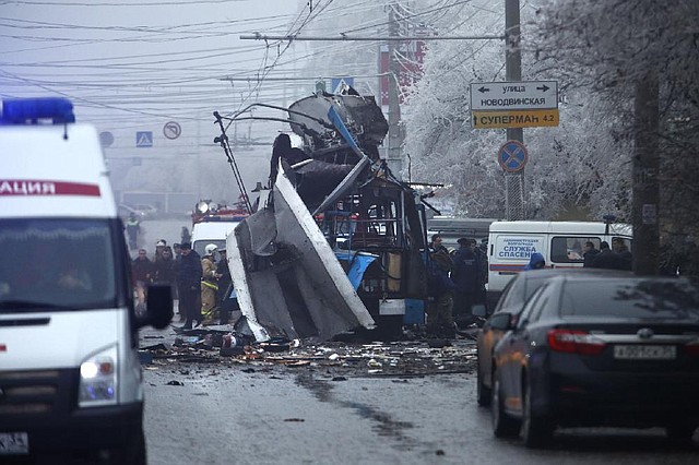 Experts and police officers examine a site of a trolleybus explosion in Volgograd, Russia Monday, Dec. 30, 2013. A bomb blast tore through the trolleybus in the city of Volgograd on Monday morning, killing at least 10 people a day after a suicide bombing that killed at 17 at the citys main railway station. (AP Photo/Denis Tyrin)
