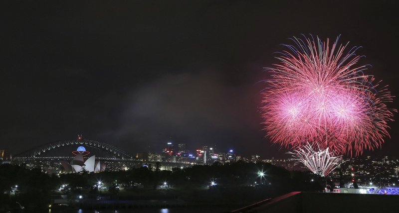 Fireworks explode near the Harbor Bridge and the Opera House during New Year's Eve celebrations in Sydney, Australia, on Tuesday, Dec. 31, 2013. 