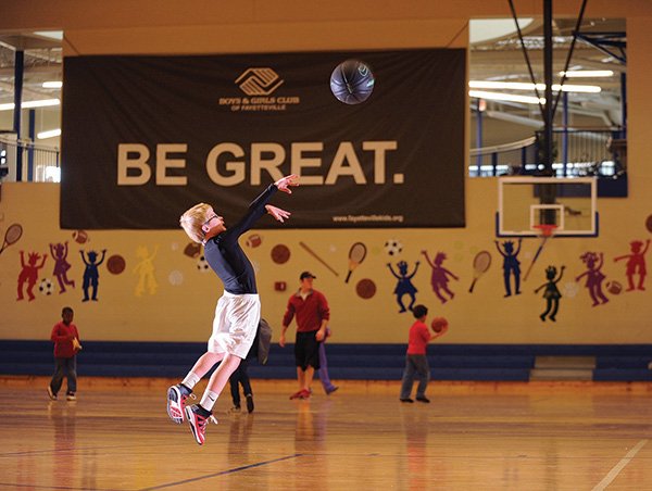 STAFF PHOTO ANDY SHUPE 
Eric Henderson, 8, of West Fork takes a 3-point shot as he plays Monday in the main gymnasium at the Boys & Girls Club of Fayetteville. Club officials are planning the construction of additional space on the north side of the building to include a new gymnasium and classroom space.