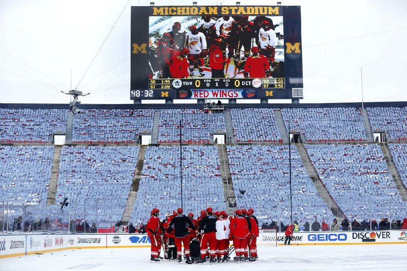The Detroit Red Wings gather at center ice during Tuesday’s practice on the outdoor rink at Michigan Stadium in Ann Arbor, Mich., where they’ll face the Toronto Maple Leafs in today’s NHL Winter Classic. 