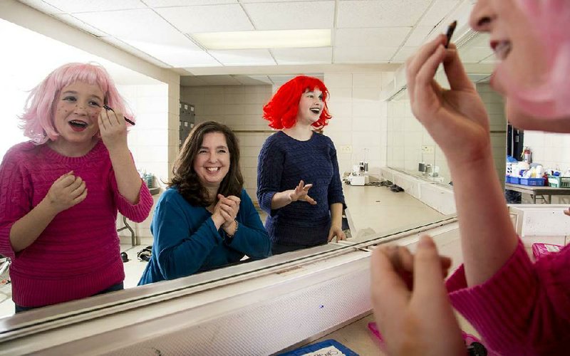 Montana Bartole, 11, (left) and Mattingly Bartole, 13, clown around with their mother, Loren Bartole, backstage at the Arkansas Arts Center’s Children’s Theatre. They say theater is a get-out-of-house activity that requires plenty of parental support and fosters family bonding. 