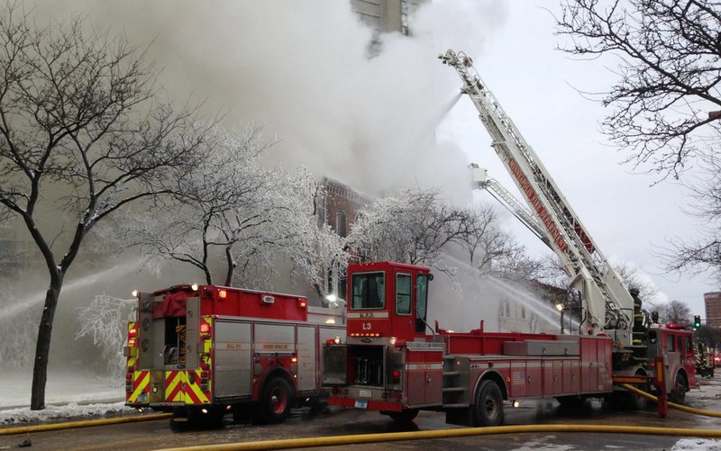 Firefighters work the scene where a fire engulfed several apartment units in the Cedar Riverside neighborhood, in Minneapolis on Wednesday. Authorities say at least 13 people have been hurt. 