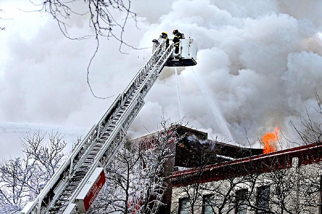 Firefighters work Wednesday to extinguish a fire that damaged several apartment units in the Cedar Riverside neighborhood in Minneapolis after an explosion was reported at 8:15 a.m. Authorities say 14 people were taken to hospitals and six were reported in critical condition.