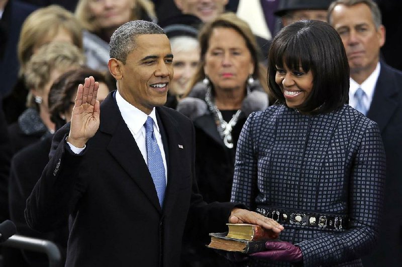 President Barack Obama received the oath of office while first lady Michelle Obama received a stamp of approval for her bangs. 