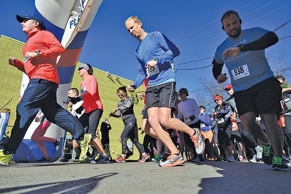 STAFF PHOTOS ANTHONY REYES 
Runners depart Wednesday at the start of the Fleet Feet New Years Day 10K/4K at Clubhaus Fitness in Fayetteville. The race provided a good start for New Year’s resolutions for many runners and walkers in Northwest Arkansas.