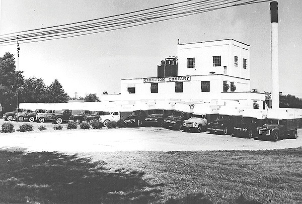 COURTESY PHOTO ROGERS HISTORICAL MUSEUM 
The Carnation Milk Plant at 206 W. Birch about 1950. Notice all of the trucks used to pick up milk cans from more than 1,200 area farmers. Today the complex is the home of Wildwood Auction Company.
