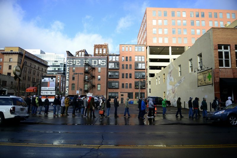 Customers wait in line, which was more than 300 deep by 10 a.m., on the first day of retail marijuana sales at LoDo Wellness in Denver on Wednesday Jan. 1, 2014. 